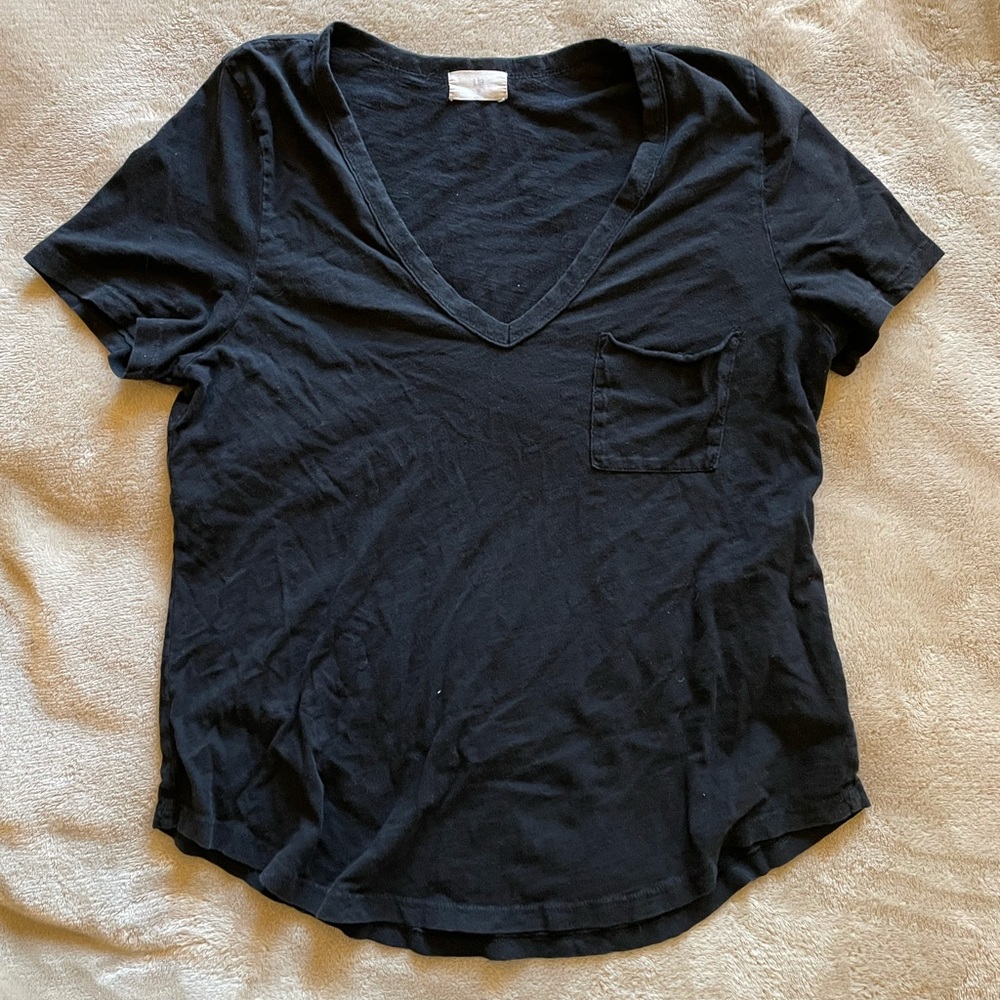 Deep v neck, black t-shirt. Cute pocket detail, and a scooped bottom hem!